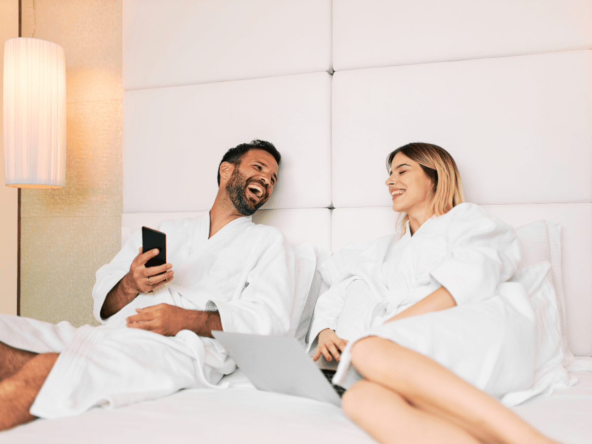 Couple in hotel room streaming content on Smartell IPTV